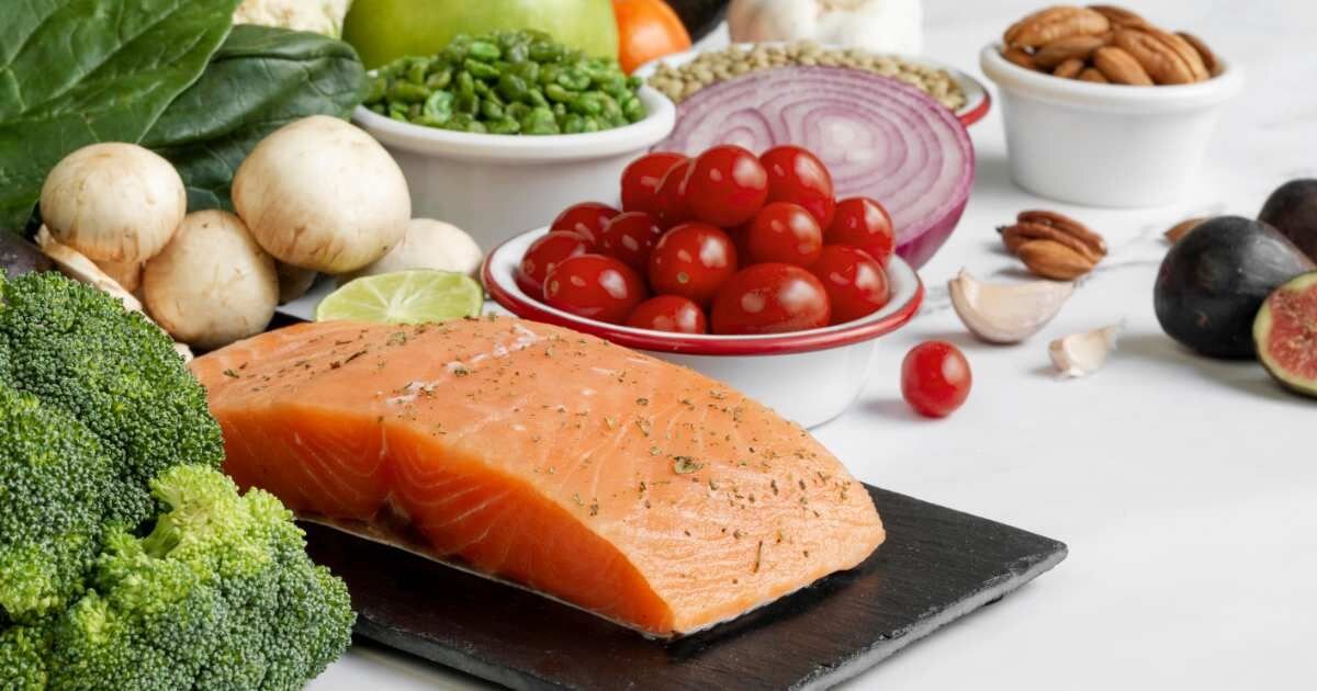 Salmon and fresh vegetables arranged on a table