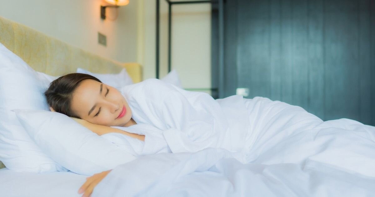 women resting happily in bed 