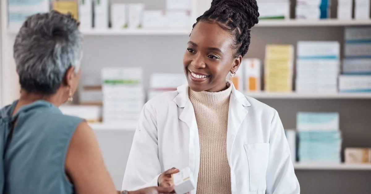 Pharmacist assisting patient with medication consultation