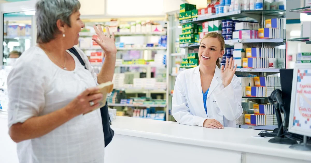 Pharmacist greeting customer at pharmacy counter